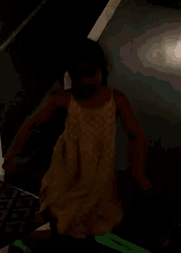 a little girl in a yellow dress is dancing on a staircase