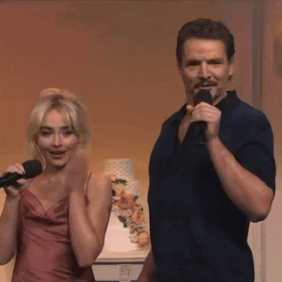 a man is holding a microphone next to a woman who is singing into it