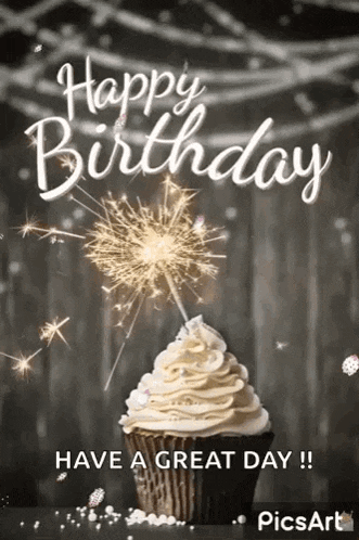 a cupcake with whipped cream and a sparkler on top of it .