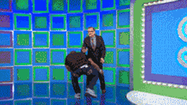 a man in a suit and tie is standing next to another man on a blue and green checkered floor
