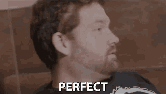 a close up of a man 's face with the words `` perfect '' written on the bottom .