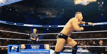 a wrestling match between drew mcintyre and randy orton is being shown