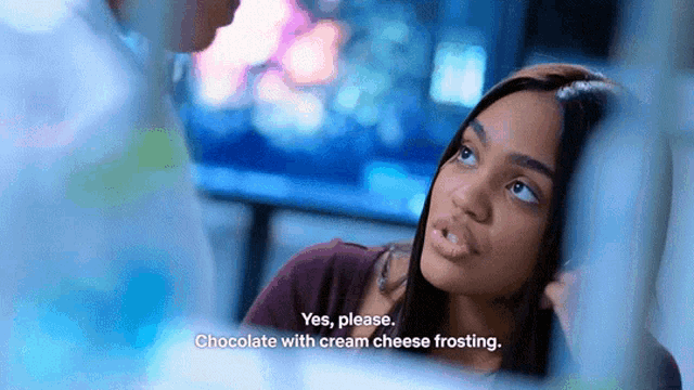 a woman is talking to a man in a room and says yes please chocolate with cream cheese frosting .