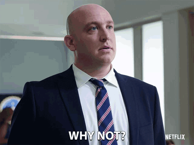 a bald man in a suit and tie is asking why not