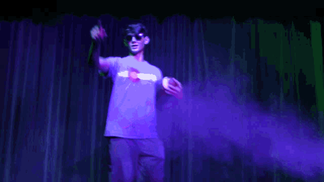 a man wearing sunglasses and a shirt that says ' superhero ' on it
