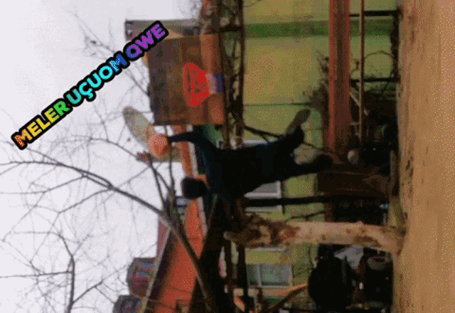 a man is doing a handstand in front of a sign that says meler ucuomowe