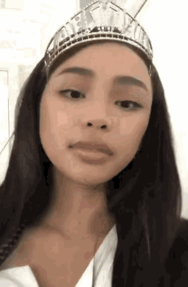 a woman wearing a tiara that says miss universe