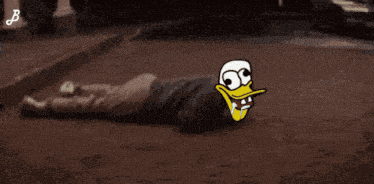 a cartoon duck is laying on the ground in front of a car