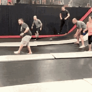 a group of people are jumping on a trampoline .