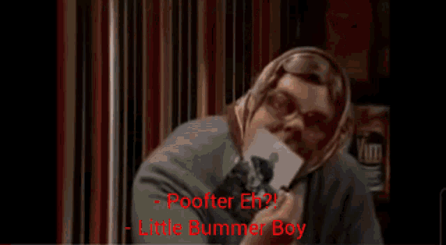 a man with a scarf around his head is holding a picture and says " poofter eh "