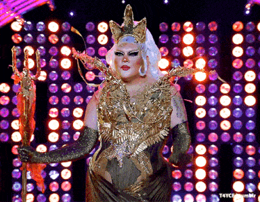 a drag queen is holding a trident in front of a purple and red background