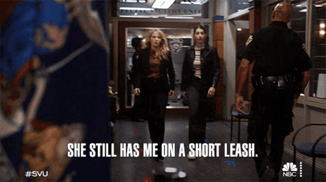 two women walking down a hallway with the words she still has me on a short leash below them