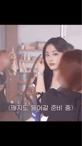 a woman is getting her hair done by a hairdresser while another woman looks on .