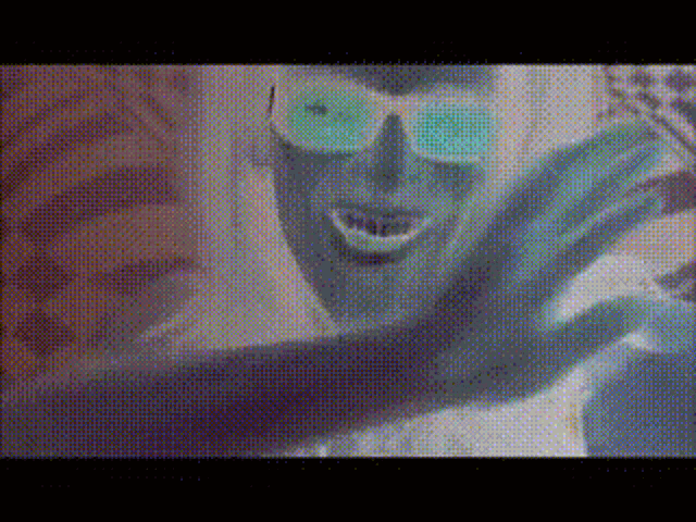 a close up of a person wearing sunglasses and a mask .