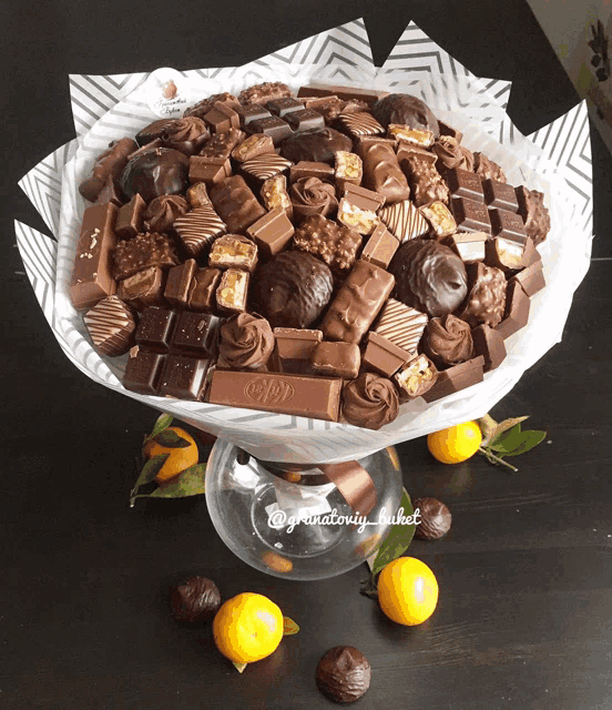 a bouquet of chocolates is sitting on a glass display