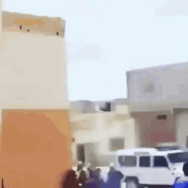 a white van is parked in front of a building in a blurry picture