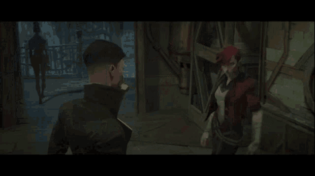 a man with red hair is holding a woman 's arm in a room .