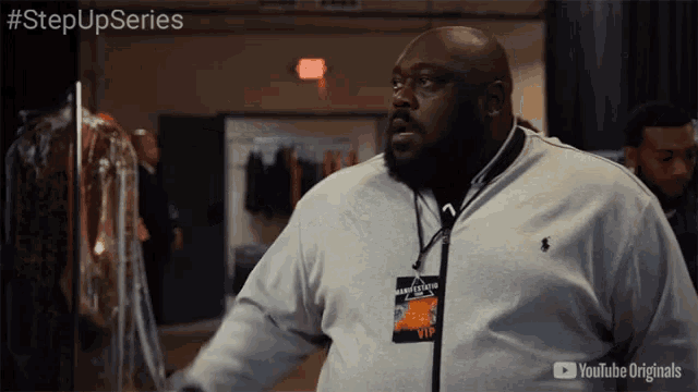 a man wearing a lanyard with a vip tag on it