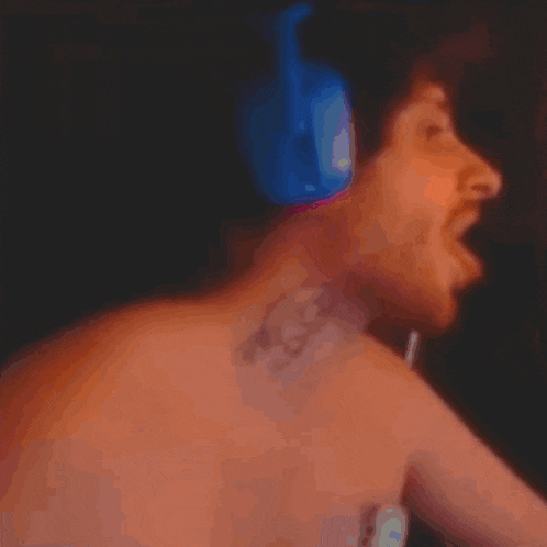 a blurry picture of a shirtless man with headphones on