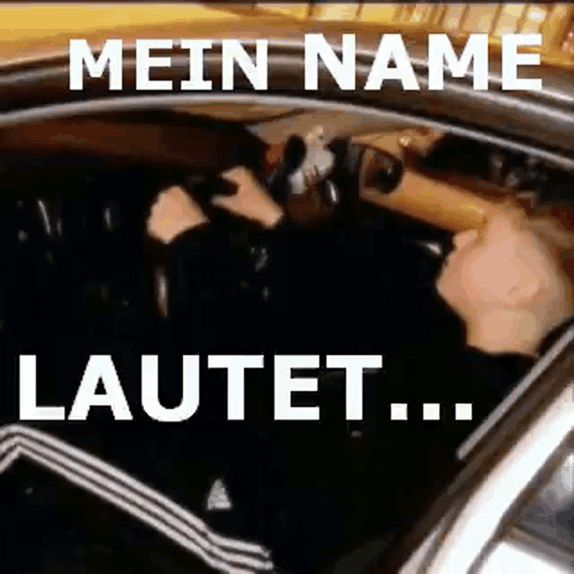 a man is driving a car with the words `` mein name lautet '' written above him .