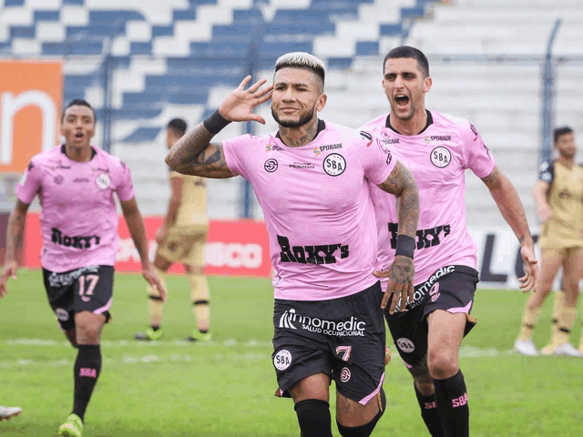 a soccer player wearing a pink jersey that says boxy 's runs on the field