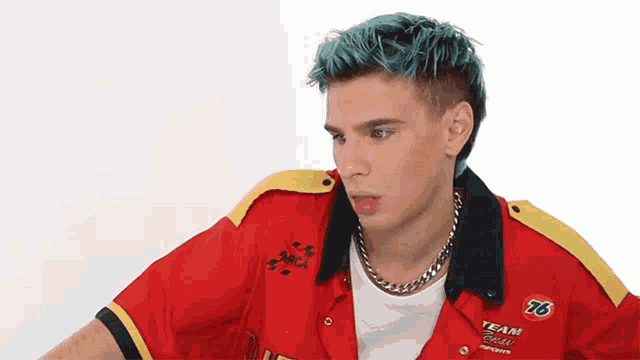 a man with blue hair is wearing a red shirt that says 76 team