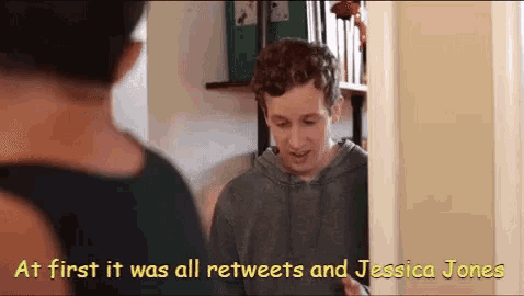 a man talking to another man in a doorway with the words at first it was all retweets and jessica jones