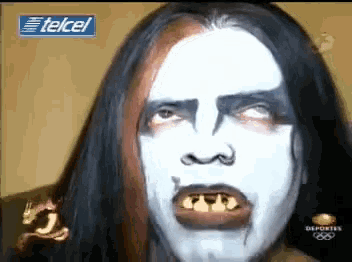 a close up of a person 's face with the telcel logo in the background