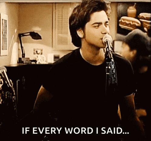 a man is singing into a microphone with the words if every word i said