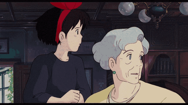 a little girl with a red bow on her head stands next to an older woman