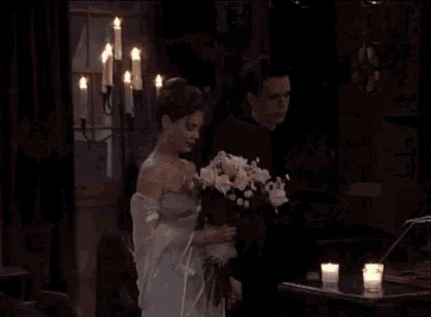 a man putting a ring on a woman 's finger