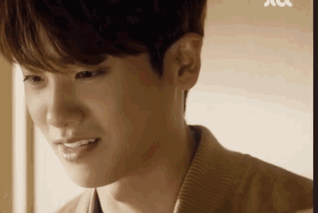 a close up of a young man 's face with a smile on it .