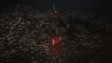 a person laying in the water with a sword in their hand
