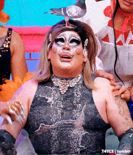 a drag queen with a bird on her head