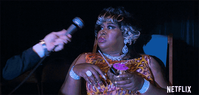 a drag queen is being interviewed by a man with a microphone and says " no "