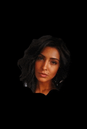 a close up of a woman 's face in a dark room