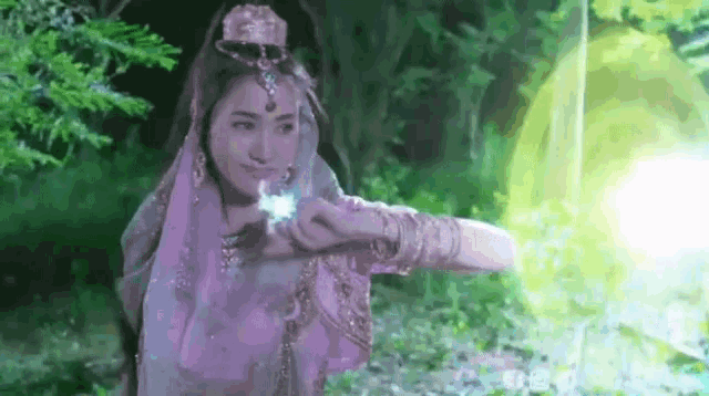a woman in a purple dress is holding a green object in her hand .