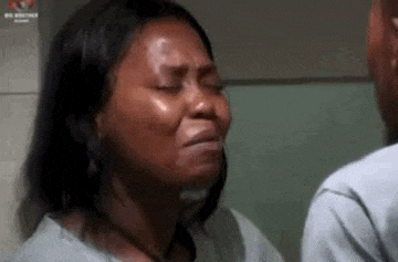 a woman is crying next to a man in a bathroom .