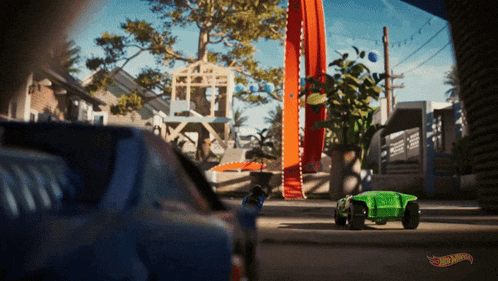 a hot wheels advertisement shows a green car driving down a track