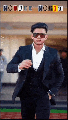 a man in a suit and sunglasses is standing in front of a sign that says " mojjee mohit "