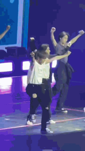 a group of young people are dancing on a stage .