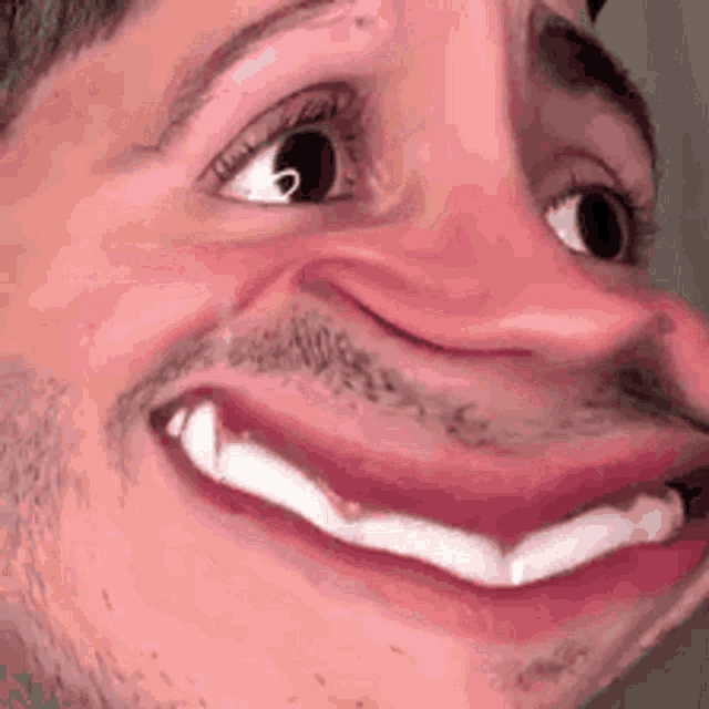 a close up of a man making a funny face with his mouth wide open and a beard .