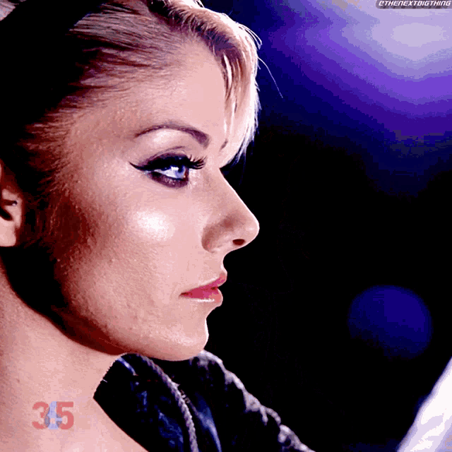 a close up of a woman 's face with the number 35 visible on her neck