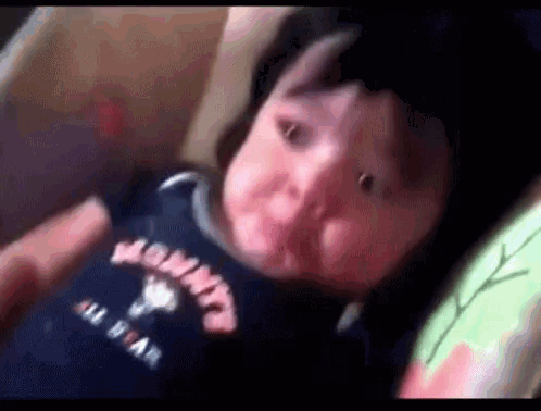 a baby is laying in a crib wearing a shirt that says mommy all star .