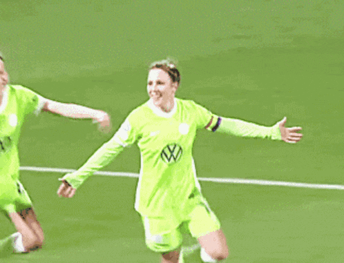 a female soccer player wearing a green jersey with the number 1 on it