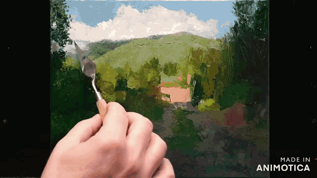 a person is painting a landscape with the words made in animotica on the bottom right