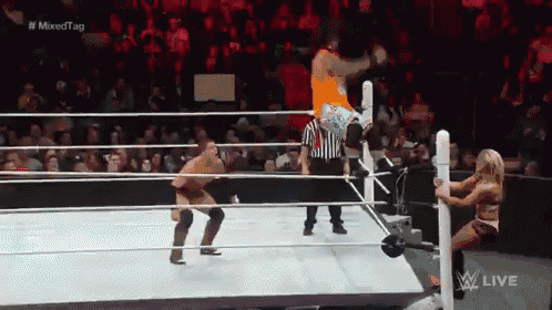 a man is jumping over a woman in a wrestling ring during a mixed tag match .