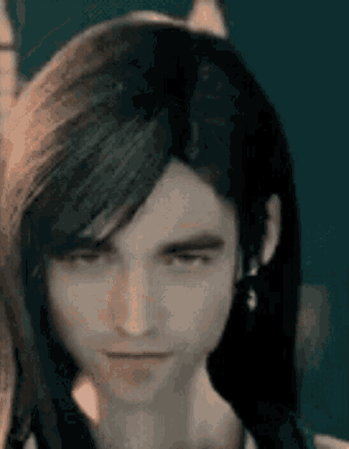 a close up of a person 's face with long black hair .