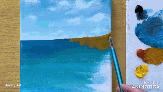 a person is painting a picture of the ocean with a blue brush