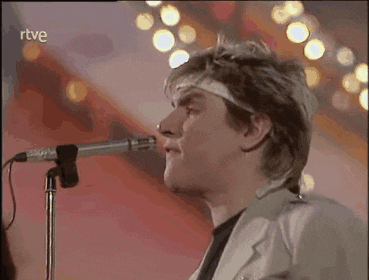 a man is singing into a microphone with the word rtve on the bottom